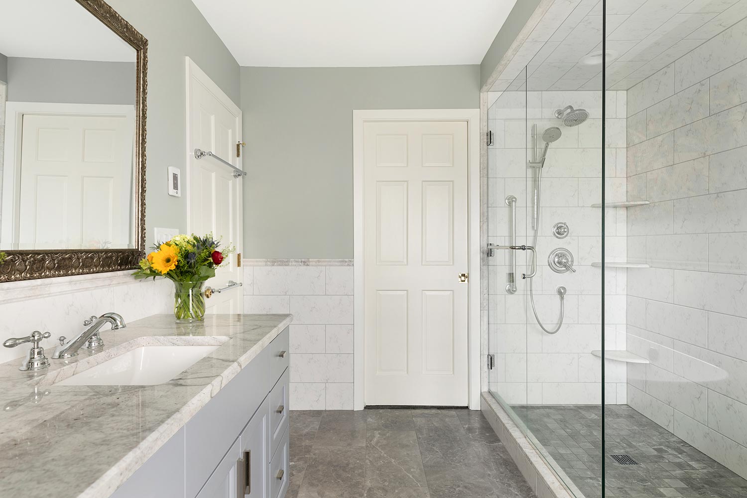 Gray and white tiled bathroom with granite counter